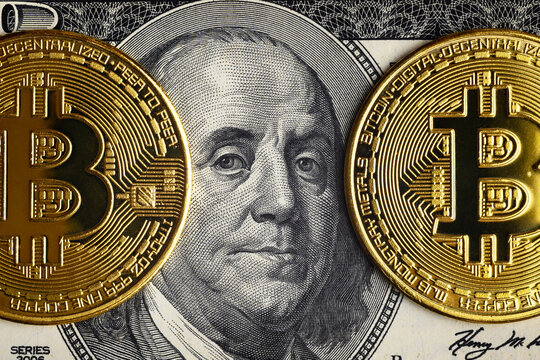 Bitcoin vs US dollar, gold bit coins on 100 dollar bill