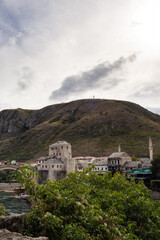 Fototapeta na wymiar View of the old town of Mostar between the mother nature. Mostar, Bosnia and Herzegovina.