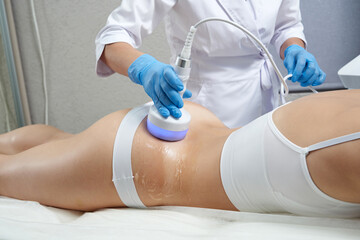 Hardware cosmetology. Body care. Spa treatment. Ultrasound cavitation body contouring treatment - obrazy, fototapety, plakaty