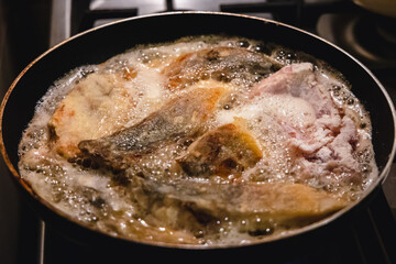 Carp is fried in a pan - a traditional Christmas dish in Poland