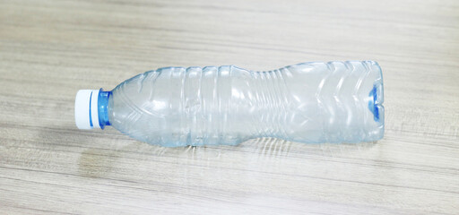 close up of an empty used plastic bottle on wood background