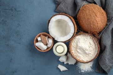 Fototapeta na wymiar Coconut milk, flour and coconuts on a dark background.