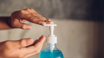 Close-up shot photo of pressing the alcohol gel.