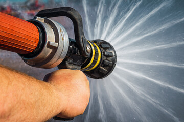 Firefighter Launch of high pressure water against fire.
