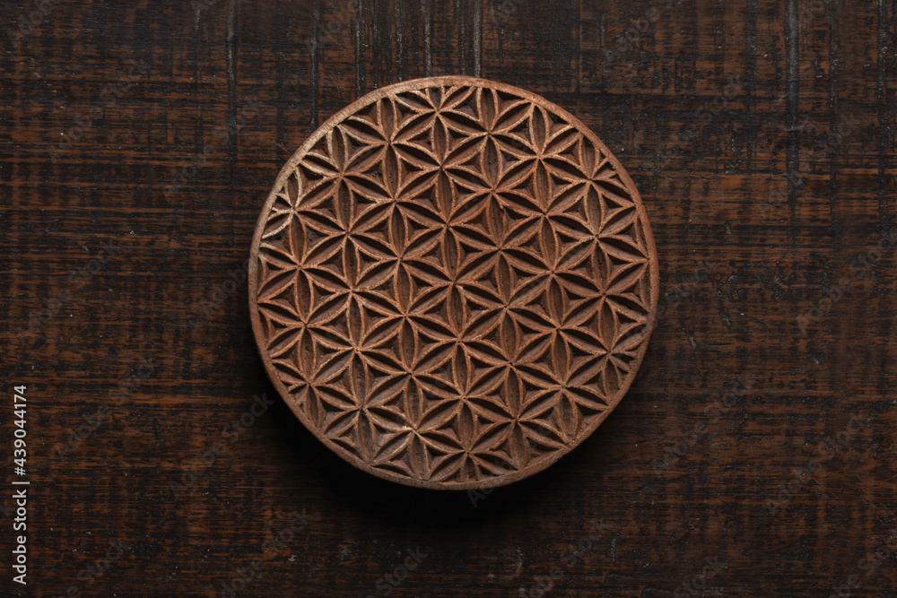 Wall mural Flower of life shape Indian wood block pattern for textile printing on rustic wood background. Block Printing,Rajasthan India Block Printing, Wood block used for handmade textile printing,Hand craft