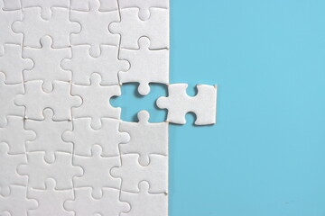 Jigsaw puzzle with missing piece. Missing puzzle pieces. Concept image of unfinished task. Completing final task, missing jigsaw puzzle pieces and business concept with a puzzle piece missing. blue