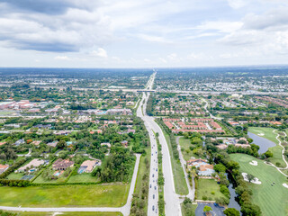 aerial drone of suburbs and city with highway

