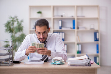 Young male bookkeeper in budget planning concept