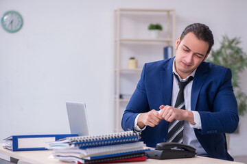 Sick male employee suffering at workplace