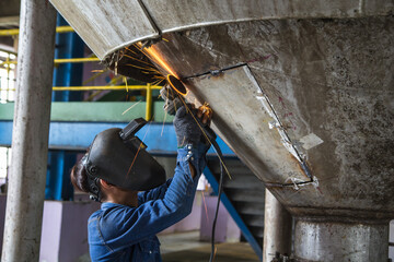Grinding stainless tank repair silo © chitsanupong