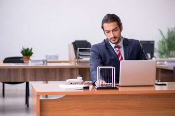 Young man businessman employee sitting in the office