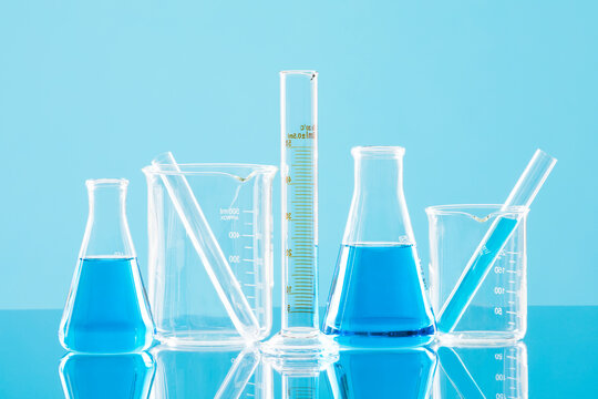 Laboratory glassware against blue background