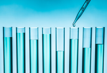 Pipette dropping liquid into test tube