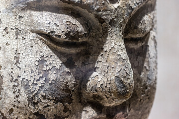 Obraz premium old wooden statue of buddha closeup