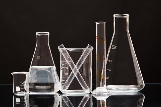 Laboratory glassware against black background