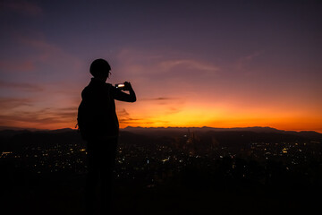 silhouette of traveling woman take a photo