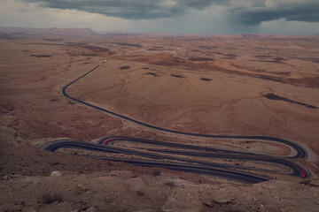 Car route along the bottom of the Makhtesh Ramon erosion crater in the Negev desert.