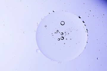 translucent oily liquid bubbles on the water surface, oil drops on the water surface
