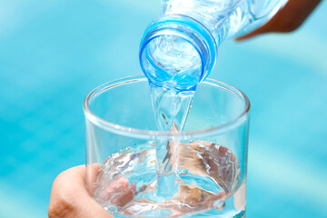 Clean water for good health.  Pouring Fresh Pure Water From Pitcher Into A Glass.