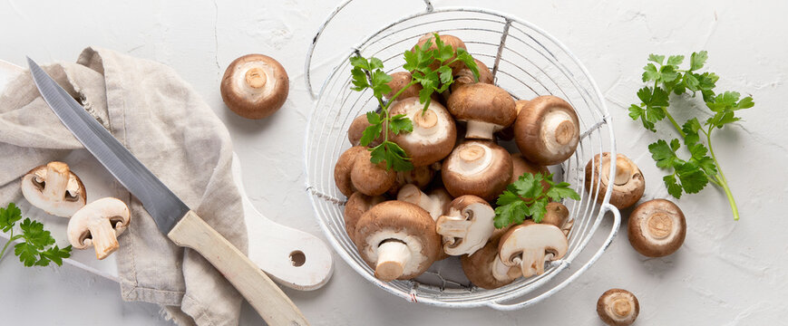 Champinion mushrooms on light background. Vegan food concept.