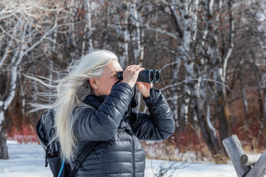 USA, Idaho, Bellevue, Senior woman using binoculars while hiking