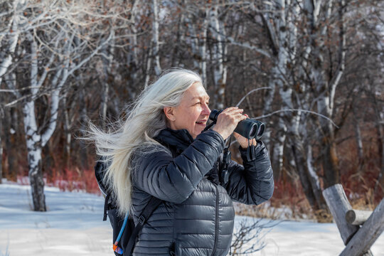 USA, Idaho, Bellevue, Senior woman using binoculars while hiking