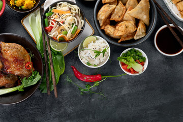 Assorted Chinese dishes and snacks on dark gray background. Traditional food concept.