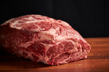 raw meat on wooden board