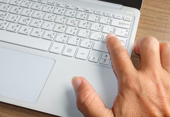 fingers typing notebook keyboard close up