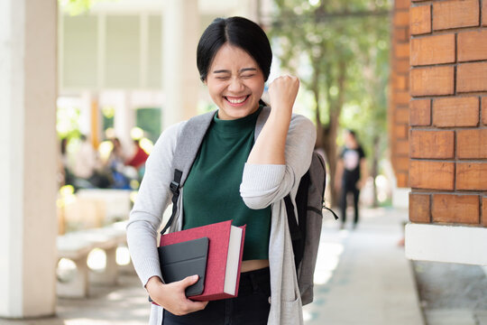 Excitted and confident asian woman college student getting back to school after reopening and vaccination rollout program