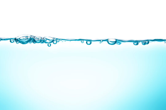 Water waves cause bubbles and splatter in clear blue water.