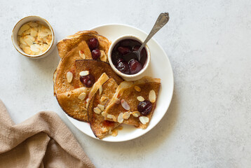 Pancakes with strawberry jam and almond close up