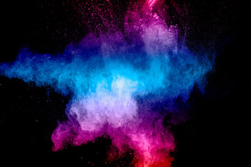 Pink blue dust particles splash on black background.Pink blue powder splash.