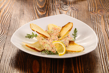 Tartar with salmon fish served lemon
