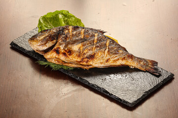 Grilled dorada servel lemon slice