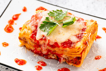 Side view on italian lasagna dish on light background