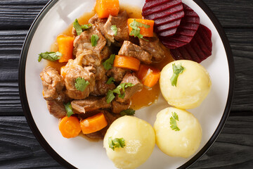 Swedish Beef Stew Kalops slow simmered with vegetables close up in the plate on the table. horizontal top view from above