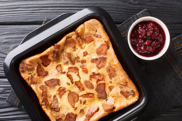 Oven Baked Swedish Bacon Pancake Flaskpannkaka close up in the baking dish on the table. Horizontal top view from above
