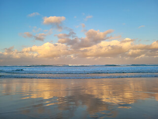 Beach sunset fluffy clouds