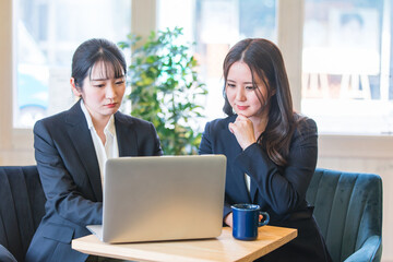 カフェで打ち合わせするビジネスウーマン（困る）
