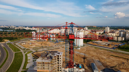 Aerial view of the new urban development. New houses are being built. The cranes are visible.