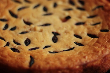 cake with honeysuckle berries on a blue plate on a wooden background
