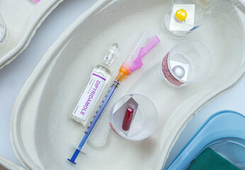 Syringes loaded with medication next to medicine vials prepared in hospital, conceptual image