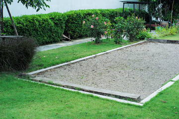 Landscape of grass field with petanque court in the garden of backyard