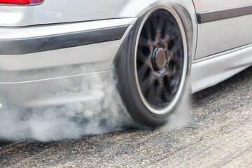 Race drift car burning tires on speed track