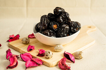 dried ajwa dates in a bowl.Ajwa Dates are a great source of fibre that benefits the digestive system.This dates variety is one of the best ingredients for muscle development, brain health and vitality