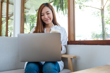 A young asian woman using and working on laptop computer
