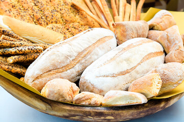 Fresh homemade bread composition in basket. Various types of wheat bakery in Sunday market. Nutrition exhibition. Italian traditional bakery. focaccia. Postcard composition. Background. Daylight