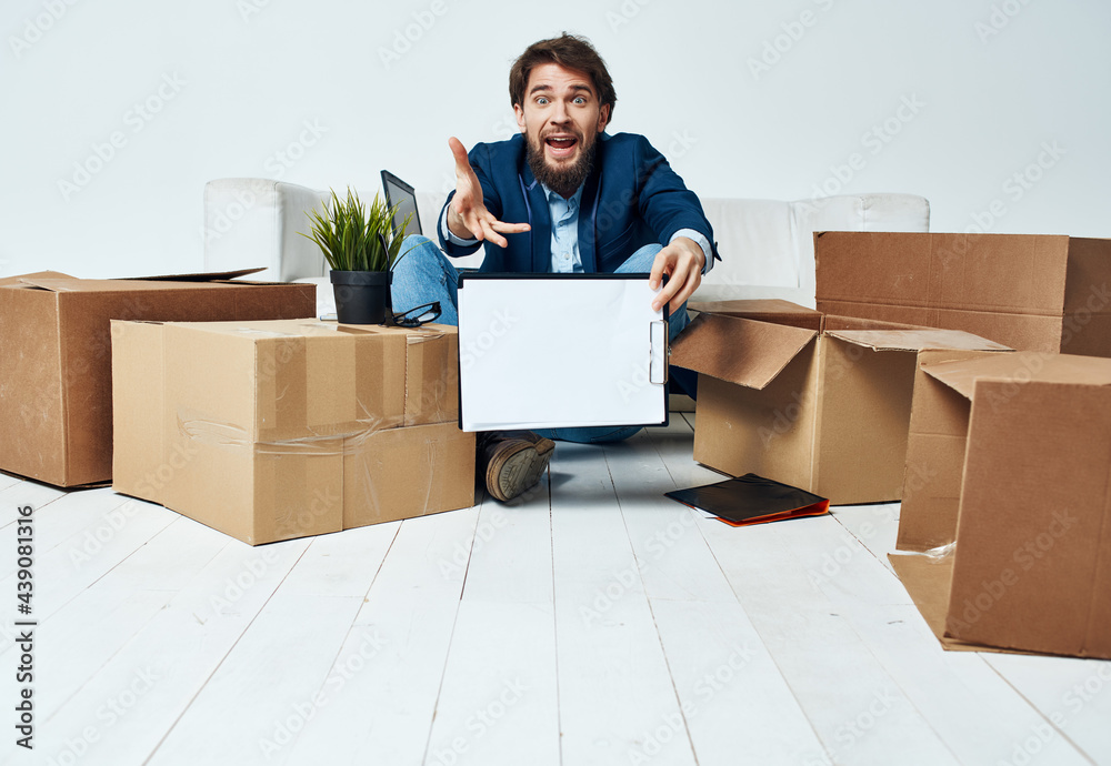 Wall mural manager moves to a new place of work cardboard boxes with things office