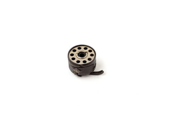 Sewing machine bobbin and bobbin case isolated on white background.